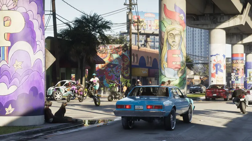 A muscle car under the elevated rail line in a mural-covered Vice City neighbourhood - image: Rockstar Games