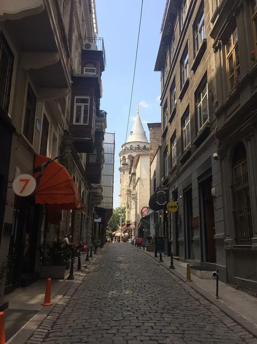 Serdar-i Ekrem Caddesi at street level, cobbles leading to Galata Tower's cone. The frame is free, and empty before 07:00. Photo: Iremnkync / Wikimedia Commons / CC BY-SA 4.0