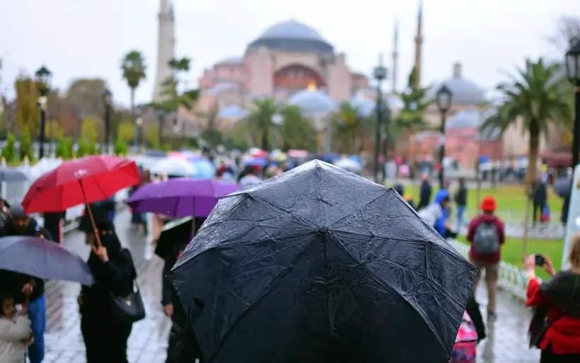 Visitors with umbrellas at Hagia Sophia on a rainy day. Covered sights such as Hagia Sophia, Topkapı Palace and the Grand Bazaar are the safer bet in bad weather. File photo from 2018. Photo: Abdulmomen Bsruki / Pexels